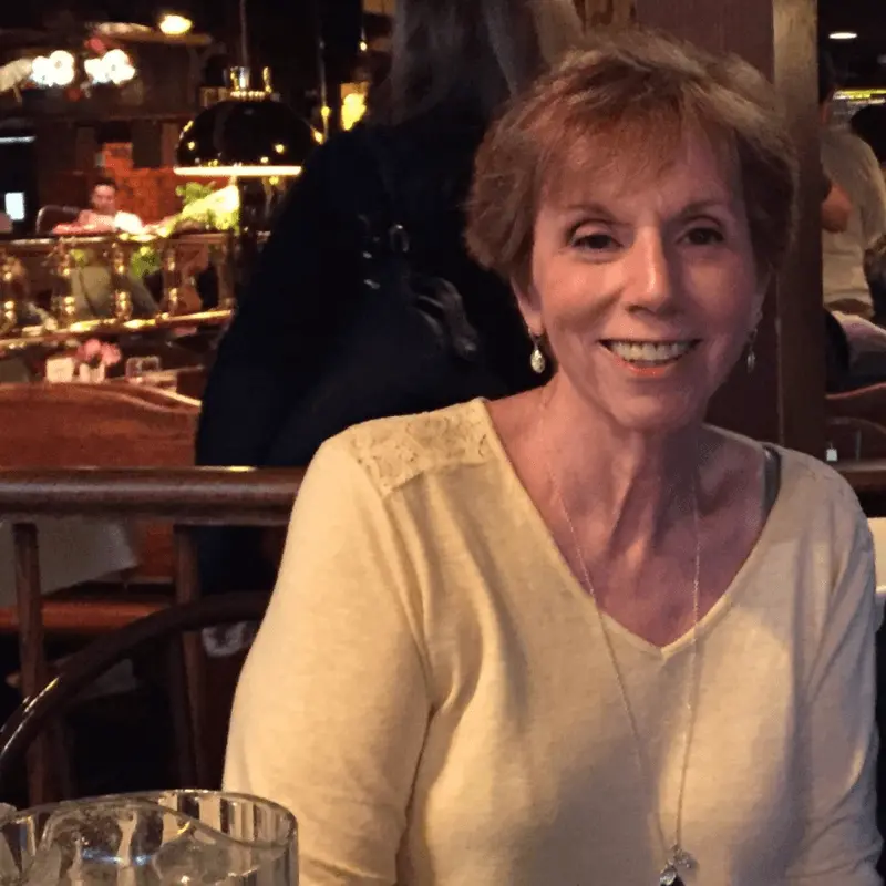 Patient advocate Bobbi Cohen smiling while seated at a restaurant