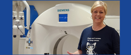 Wendy standing in front of a scanner giving a thumbs up.
